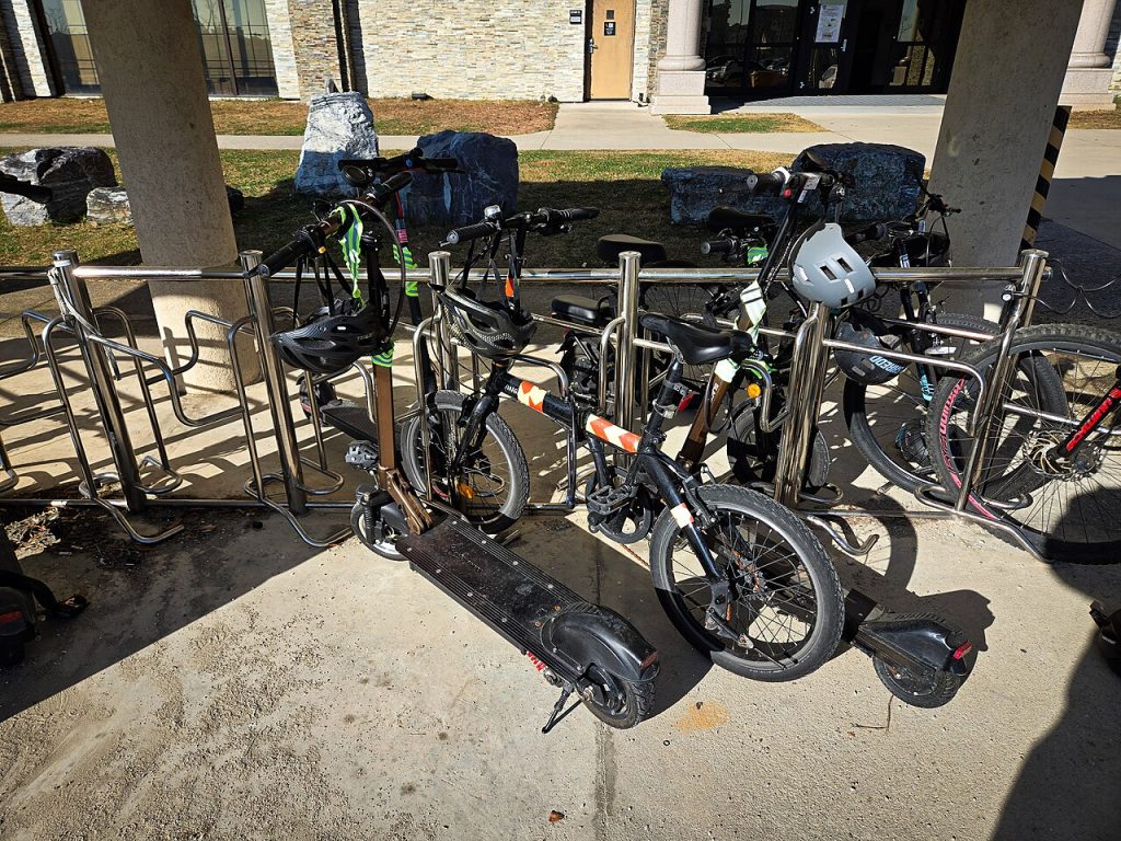 Electric bikes and scooters parked during a lithium-ion battery safety lesson