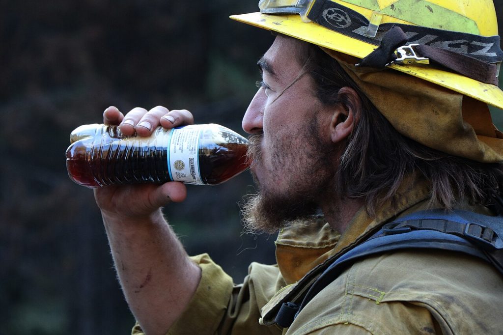 Firefighter rehydrating during a break from firefighting operations