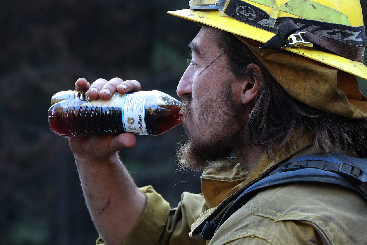 Firefighter rehydrating during a break from firefighting operations