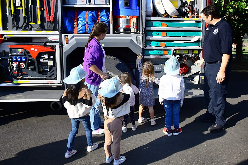 Children learning about fire safety from firefighters