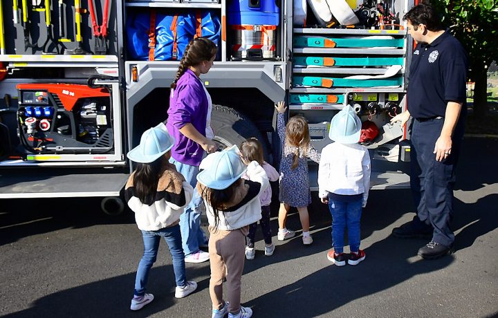 Children learning about fire safety from firefighters
