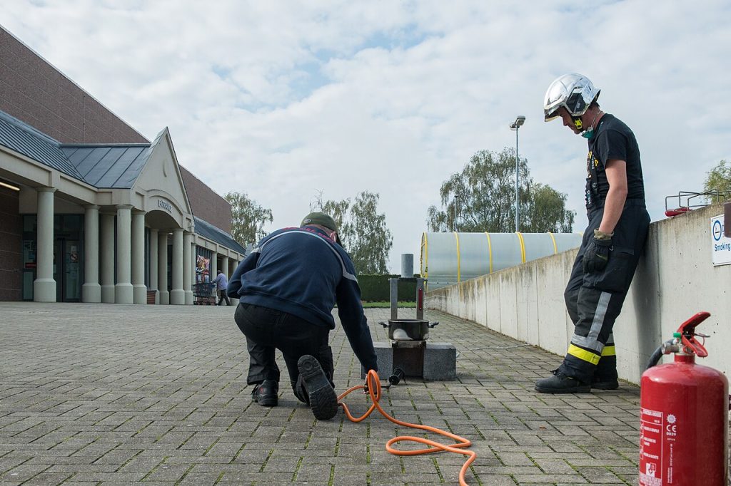 Firefighter demonstrating how a grease fire spreads