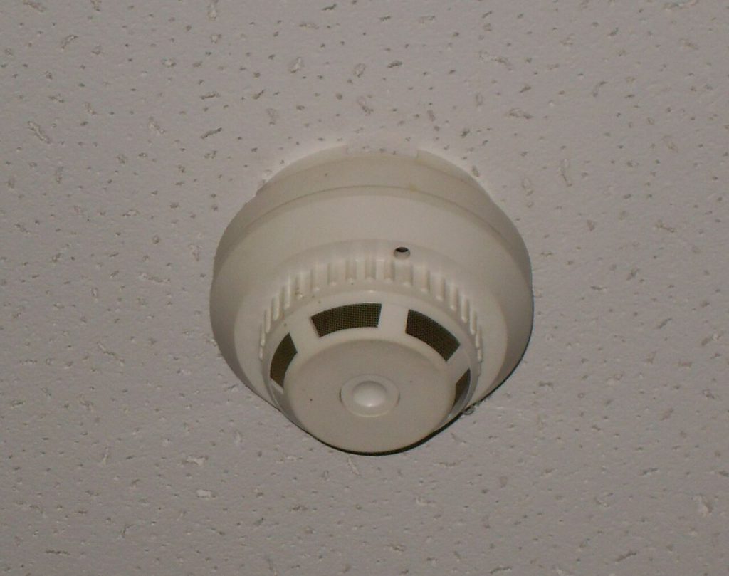 Smoke alarm mounted on a ceiling